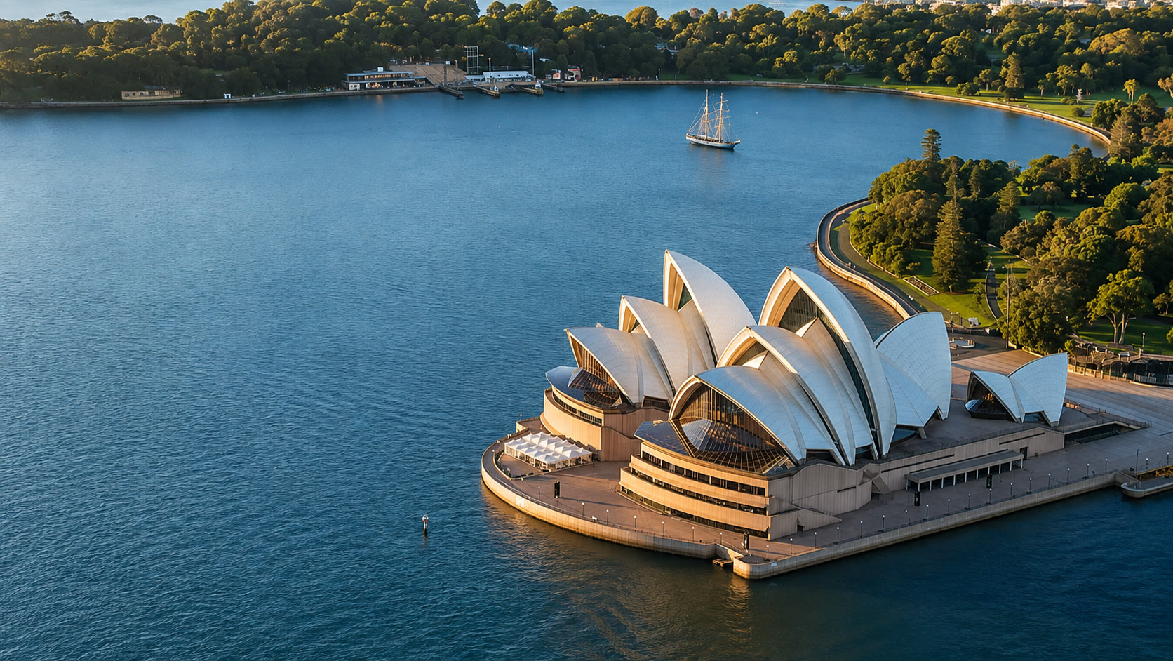 Sydney Opera House in warm afternoon light across the harbour