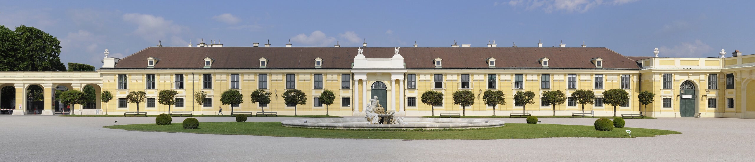 Schönbrunn Palace and its formal gardens beneath a clear Vienna sky