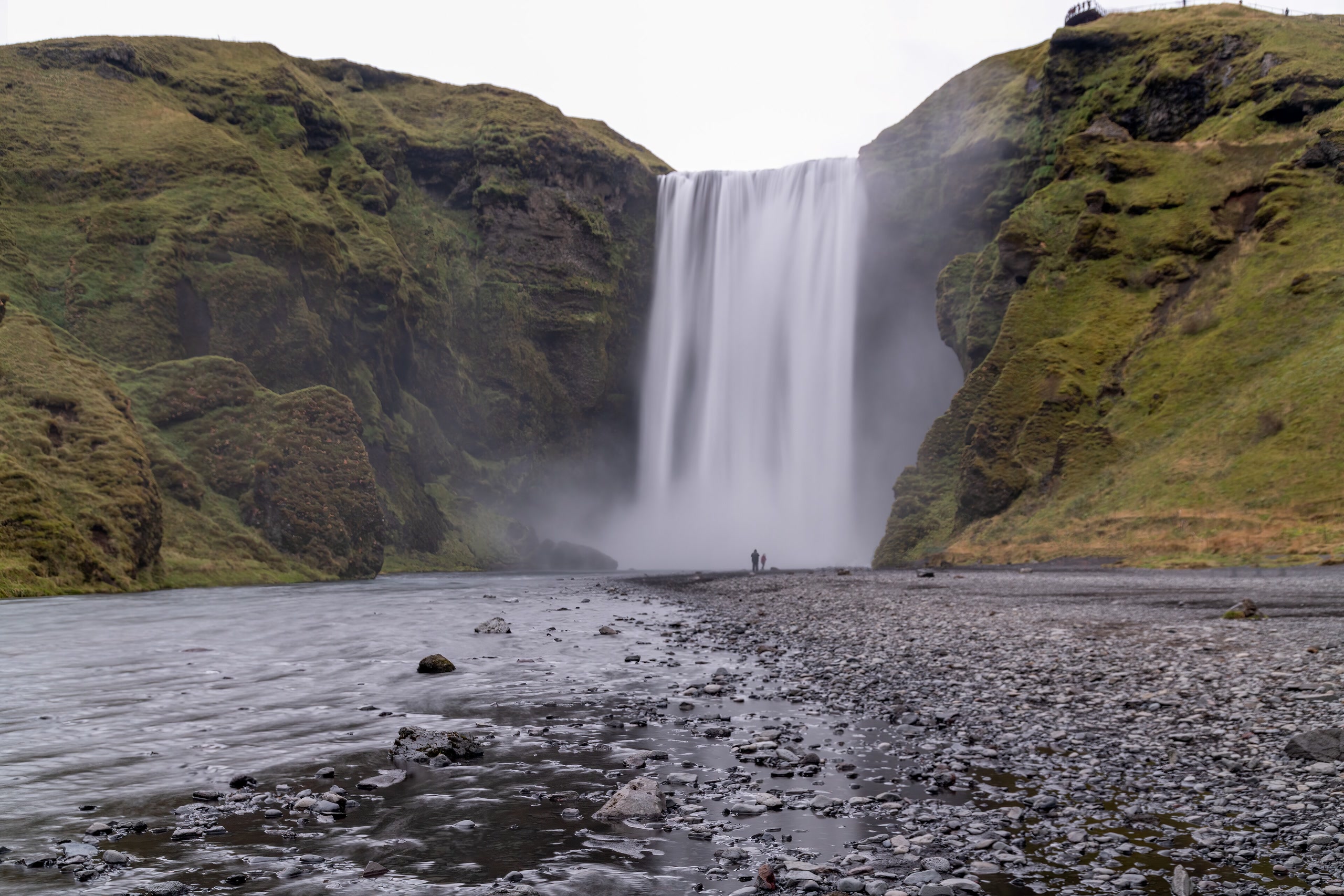 Skógafoss waterfall and its rocky stream in southern Iceland