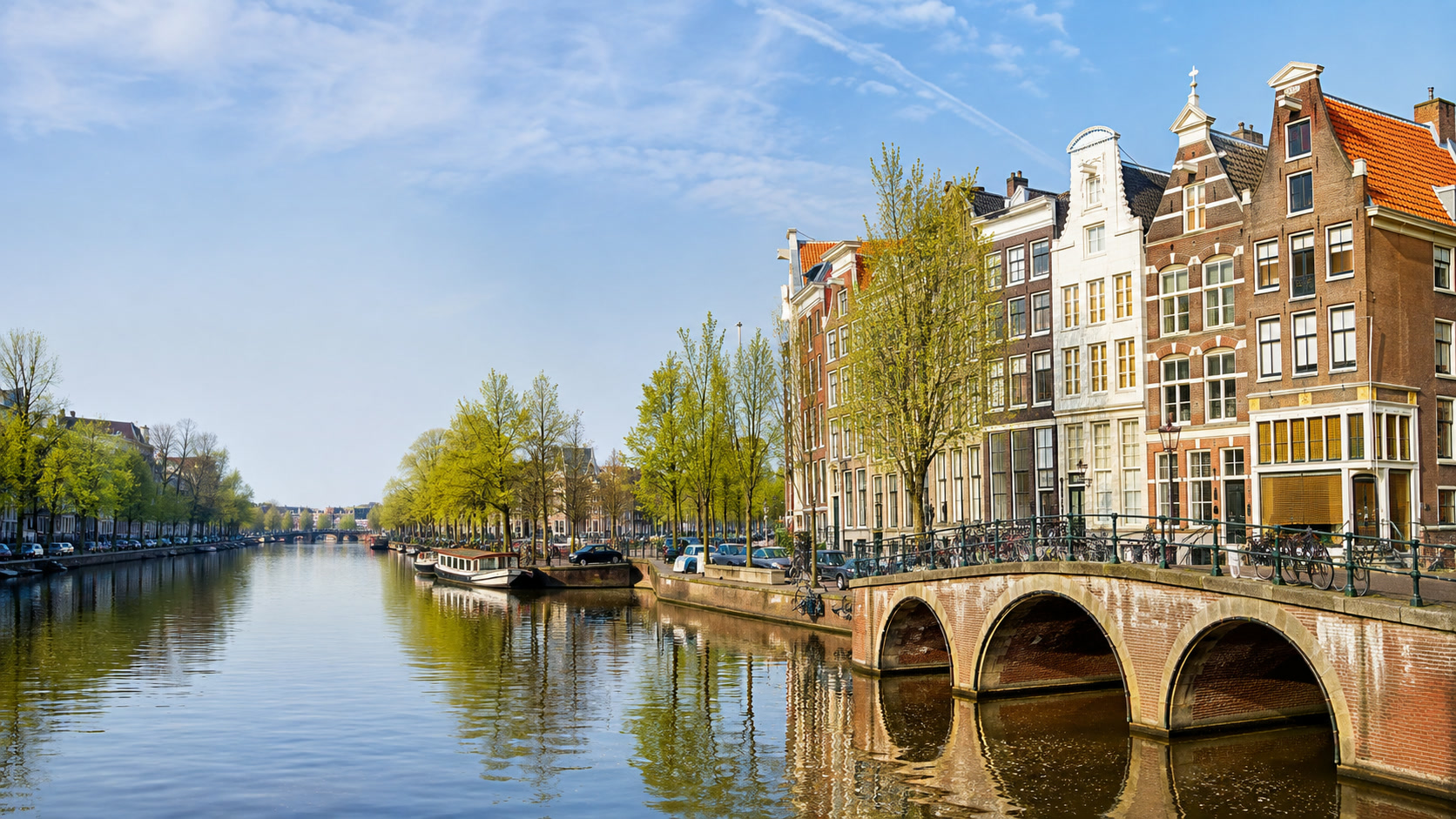 Amsterdam canal houses and a bridge in spring daylight