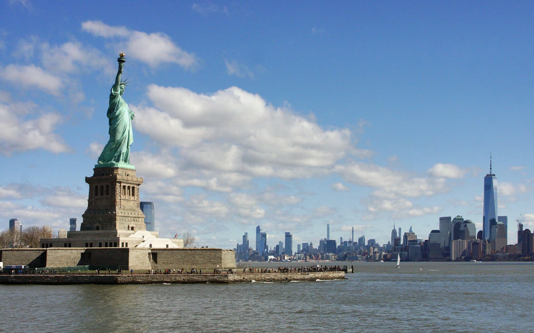 The Statue of Liberty and Manhattan skyline across New York Harbor