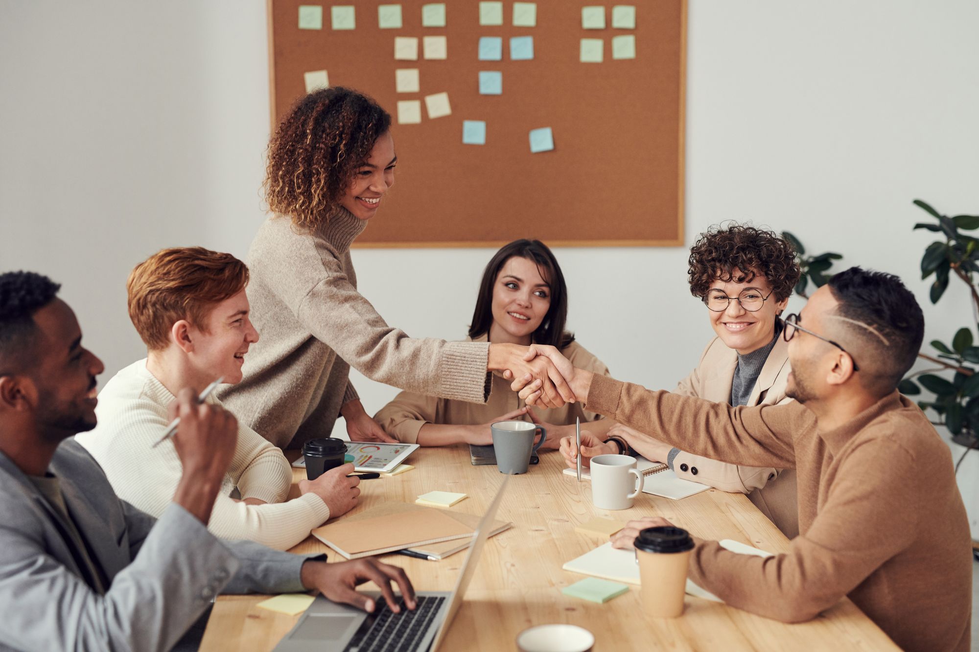 Colleagues working together around an office table